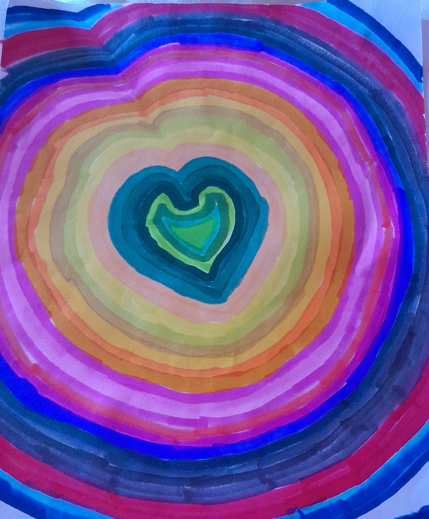 Colorful concentric circles with a heart shape in the center, featuring various shades of blue, purple, orange, pink, and green.